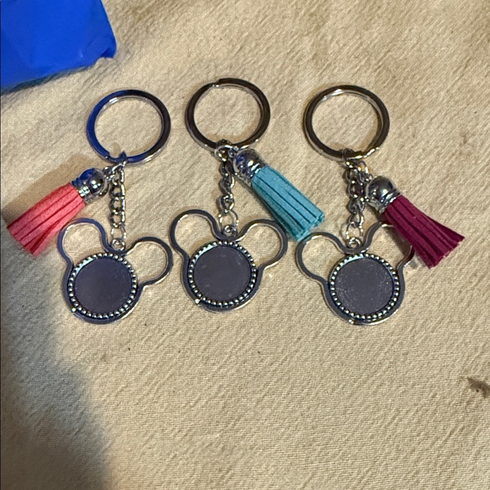 Elegant Silver Keychain Trio with Pink and Teal Tassels